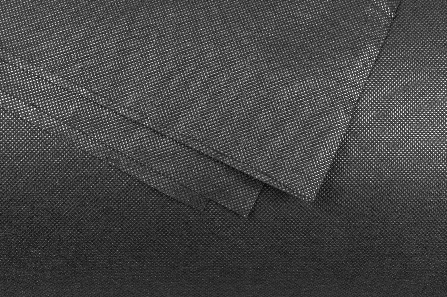 Close-up of dark non-woven weed membrane texture with stitched seam