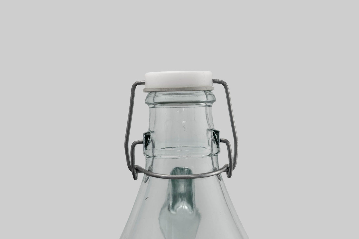 Swing-top cap on glass demijohn with wire latch and white gasket seal