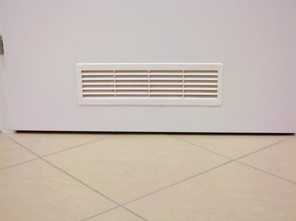 Door louvre vent grille in a rectangular recess, white horizontal slats