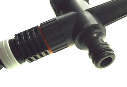 Close-up of black sprinkler nozzle and collar with orange ring detail