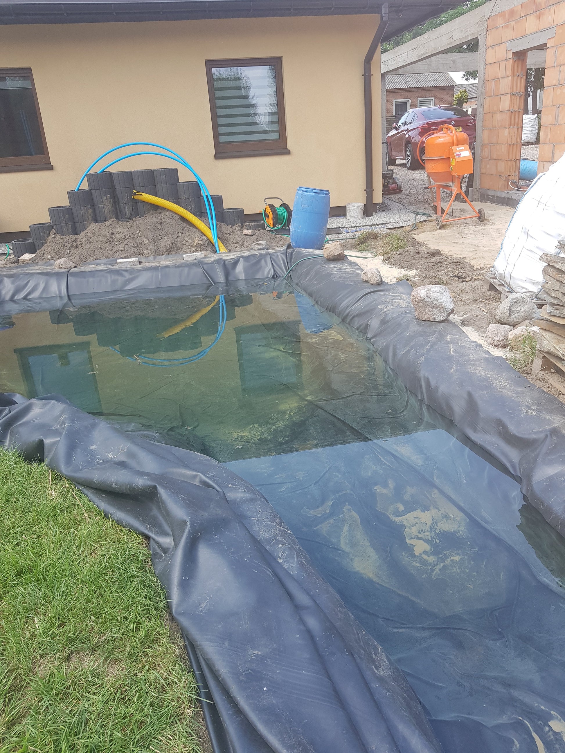 EPDM pond liner stretched in a square pond, black sheet with folded edges