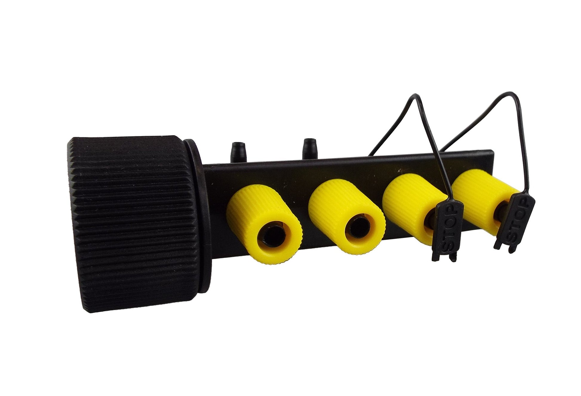 Close view of 4-way micro drip manifold: black base, four yellow outlets and valve clips