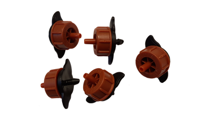 Assorted orange non-pressure drippers with black stakes, side view