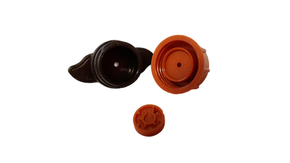Orange and black dripper components: cap, valve insert, and outlet disc