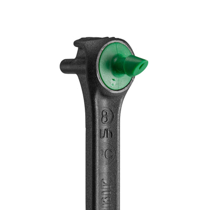 Close-up of black drip spike dripper head with green insert outlet
