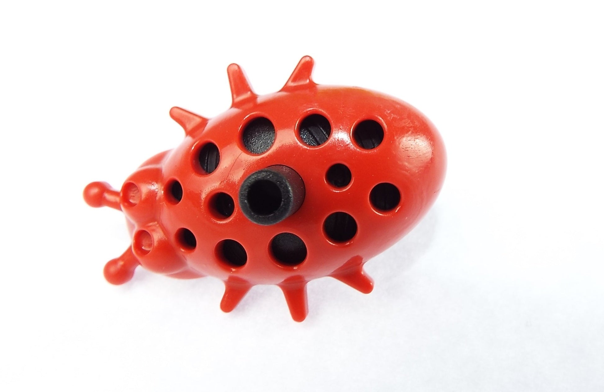 Ladybug dripper underside view, red body with black central opening and side legs