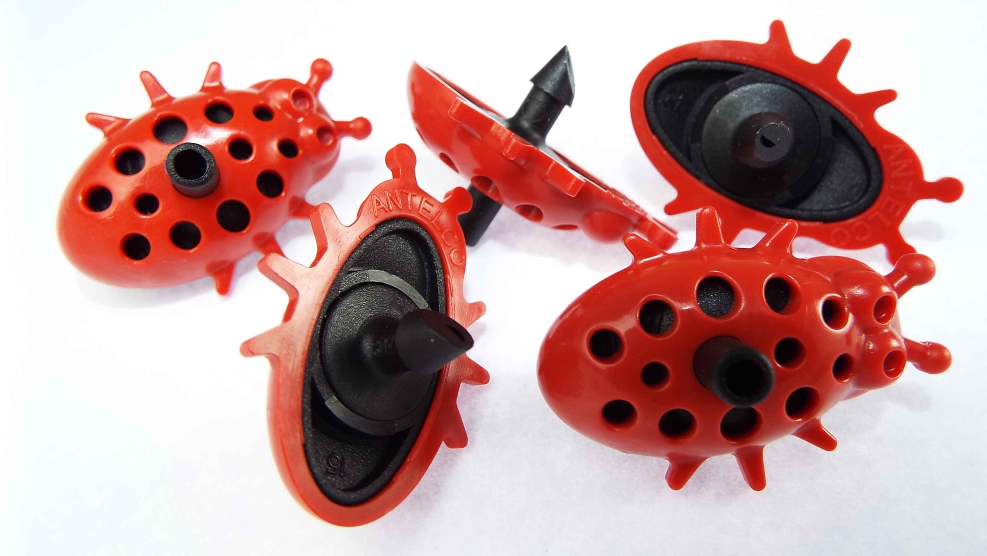 Four Ladybug drip drippers in red with black nozzles and perforated heads