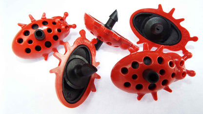 Four Ladybug drip drippers in red with black nozzles and perforated heads