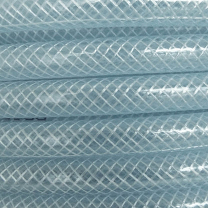 Clear braided PVC pipe close-up, crosshatch mesh pattern on the tubing