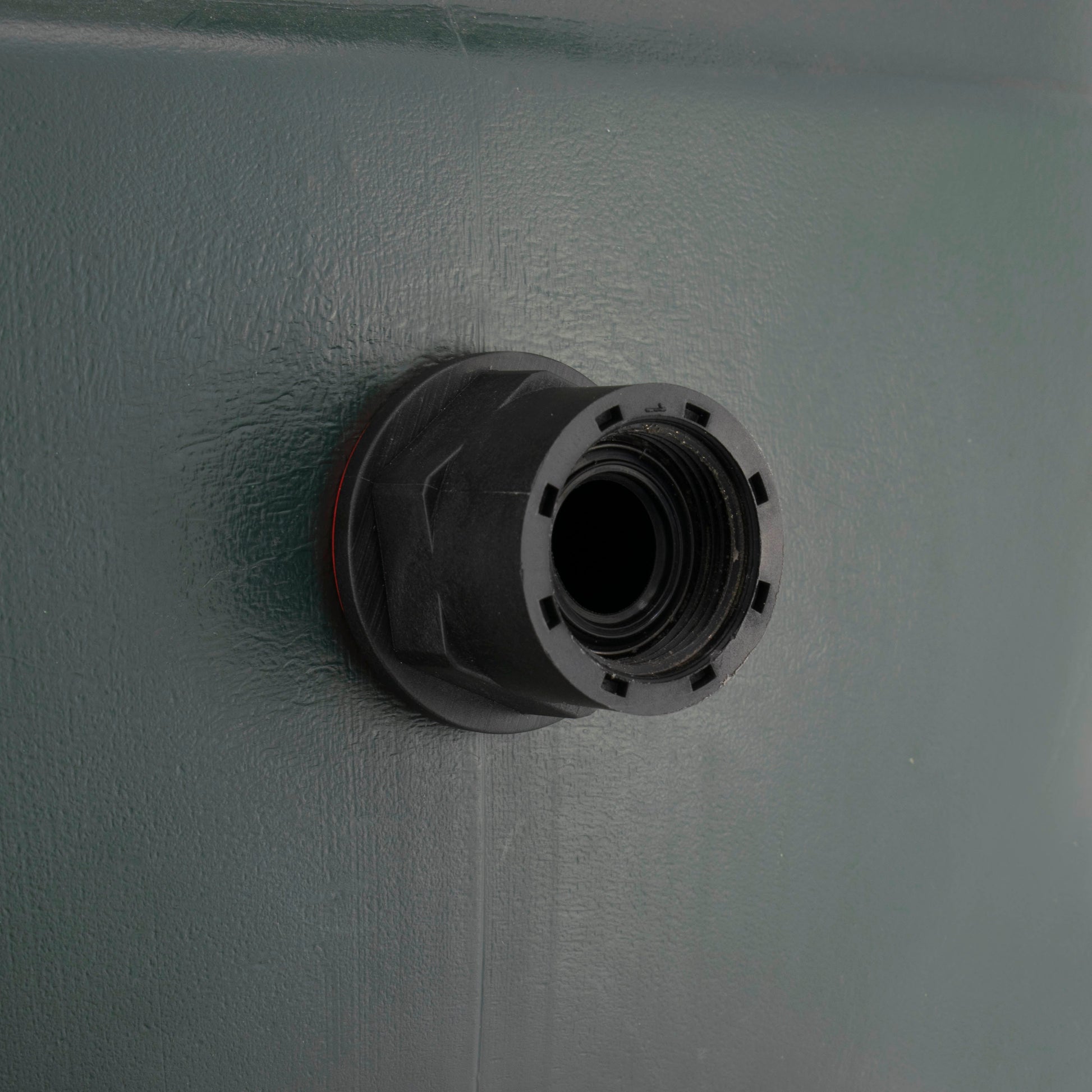 Black connector with red ring at tank inlet, threaded opening visible