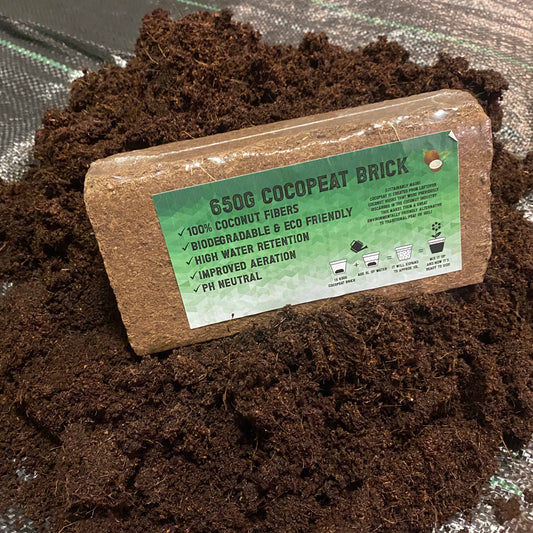 Cocopeat brick 650 g with green info label on dark coconut coir