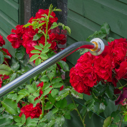 Watering lance spray head with brass-colored inlet ring and black grip