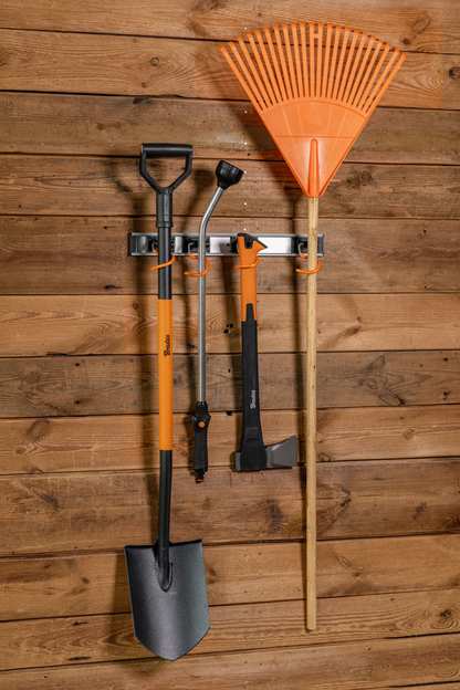 Wall-mounted tool rail holding hanging tools on 5 orange S hooks