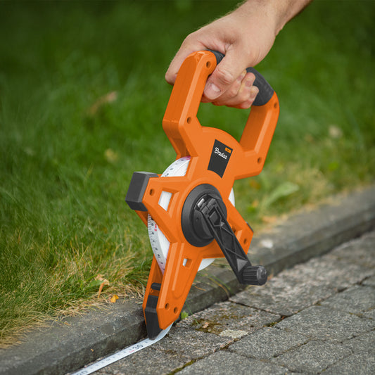 Black-and-orange coiled tape measure, 15mm wide, 30m length, hand-held handle