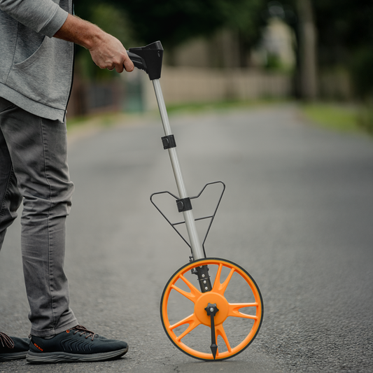 Telescopic measuring wheel with digital counter, orange spoked wheel and black handle arm