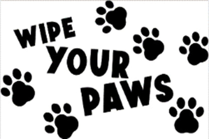 Close-up view of “WIPE YOUR PAWS” doormat with black paw prints