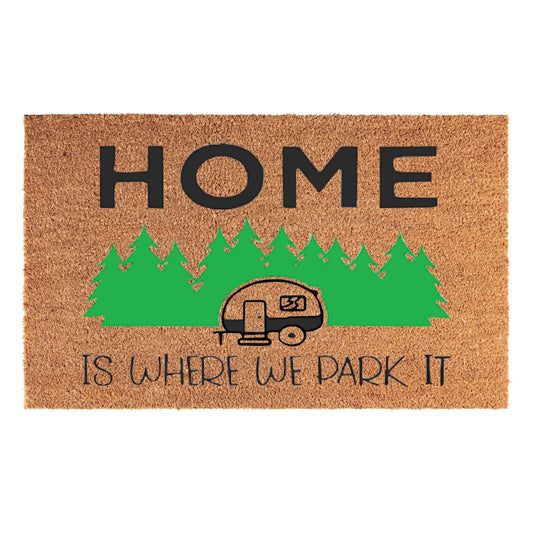 Brown doormat with 'HOME' and caravan graphic, text: 'IS WHERE WE PARK IT'.