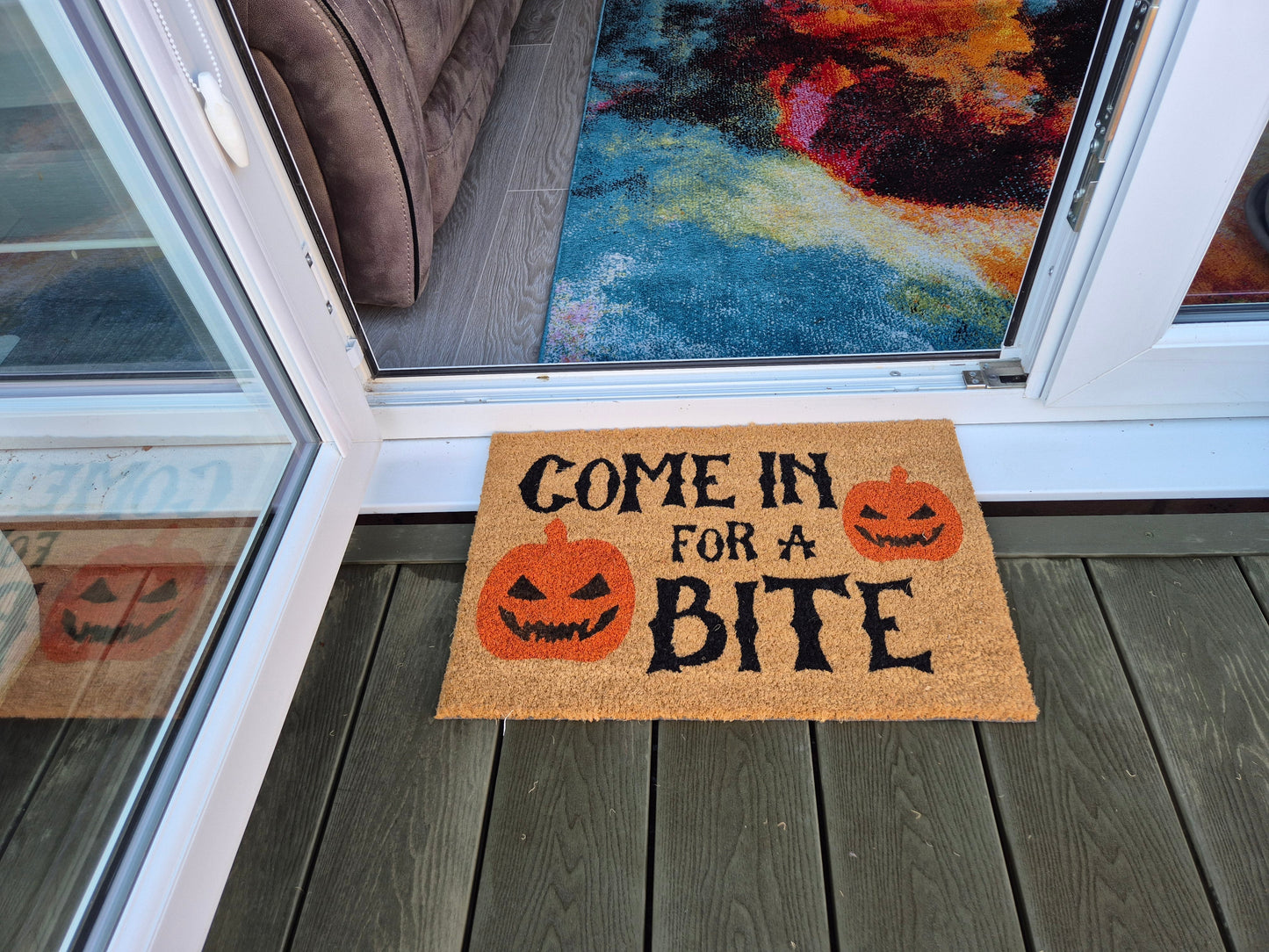 Front-door doormat: 'Come in for a Bite' pumpkin faces in orange on tan