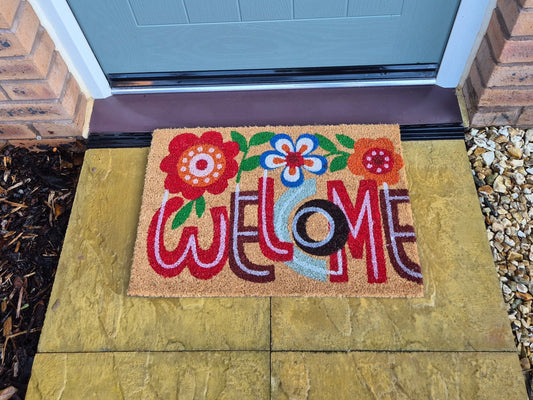 60x40 cm doormat with colorful “Welcome” lettering and flower designs