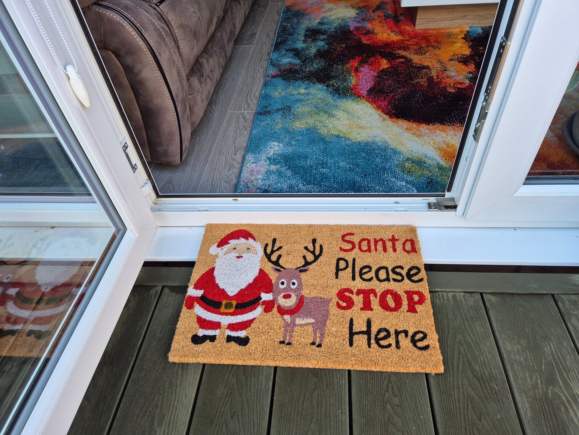 “Santa Please STOP Here” doormat featuring Santa, reindeer, and bold STOP lettering