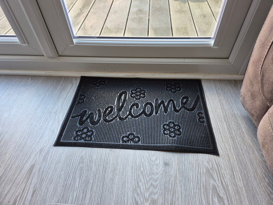 Rubber doormat 60 x 40 cm with “welcome” text and small flower icons, dark
