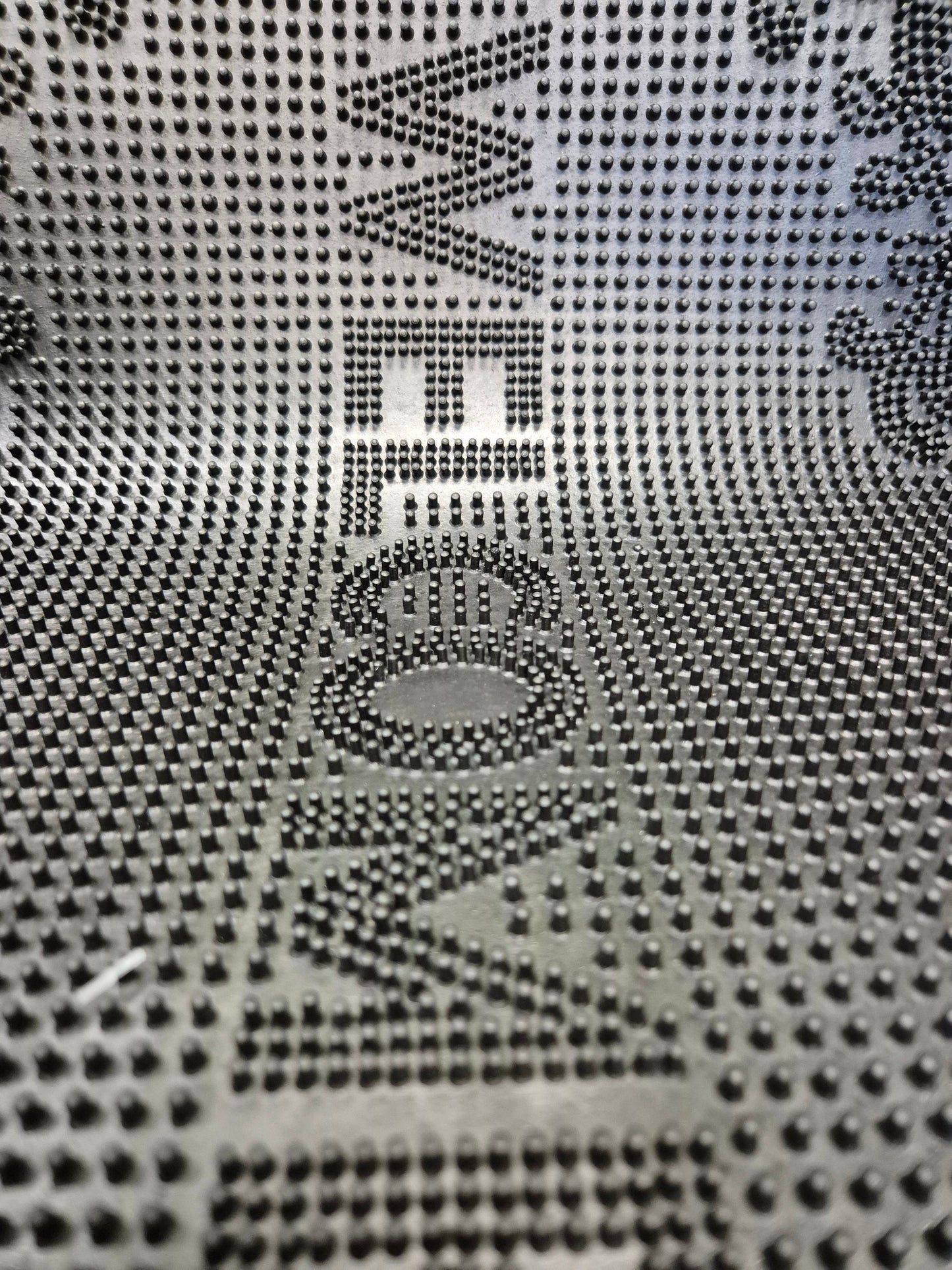 Close-up of rubber doormat texture and raised “WELCOME” emblem