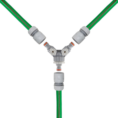 Close-up of 3-way valved mixer with green hoses and central outlet