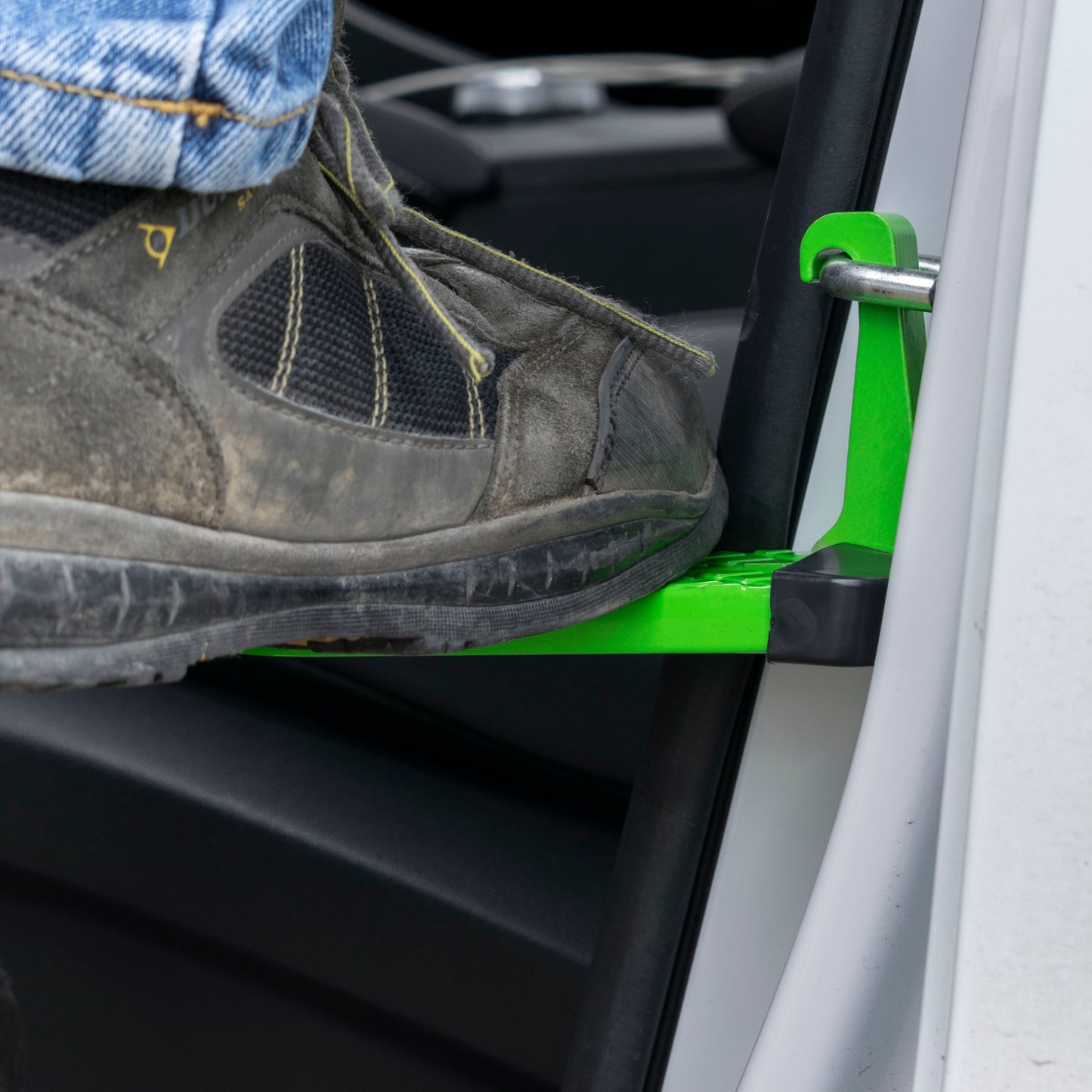 Green car door step Type A beside seat, textured platform with upright handle