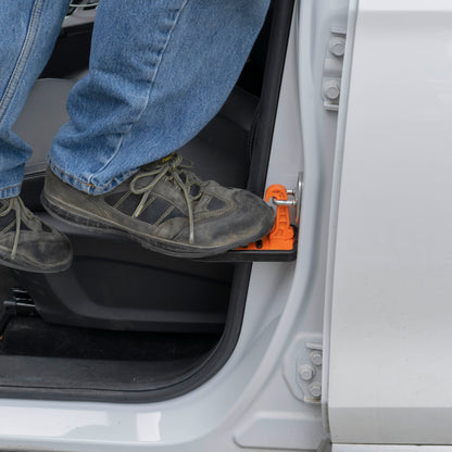 Orange Type C car door step deployed inside doorway for foot support