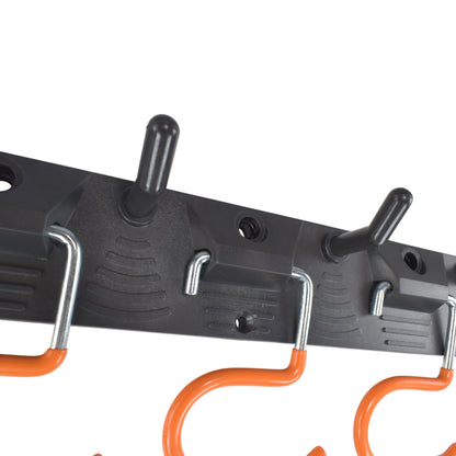 Adjustable peg hooks on black tool rail with orange hook parts