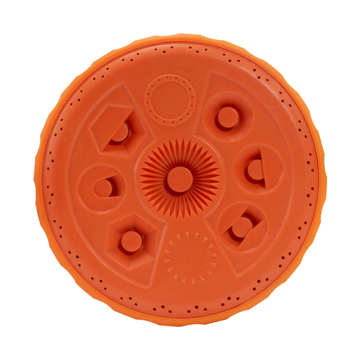 Close-up of orange sprinkler top dial with raised nozzles and circular pattern segments