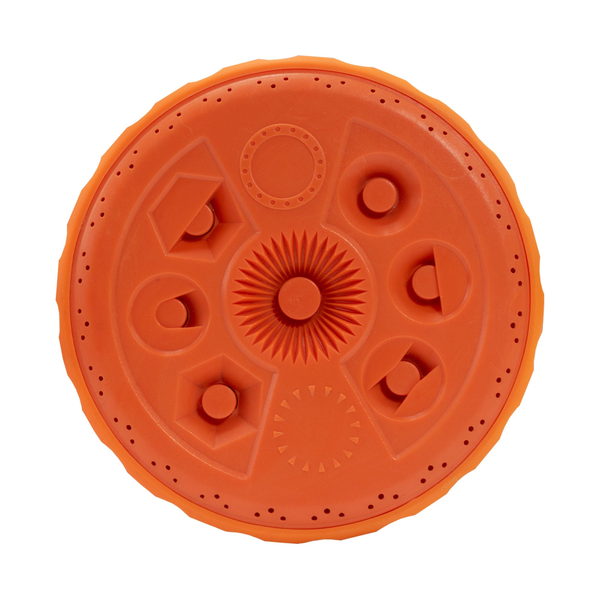 Close-up of orange sprinkler top dial with raised nozzles and circular pattern segments