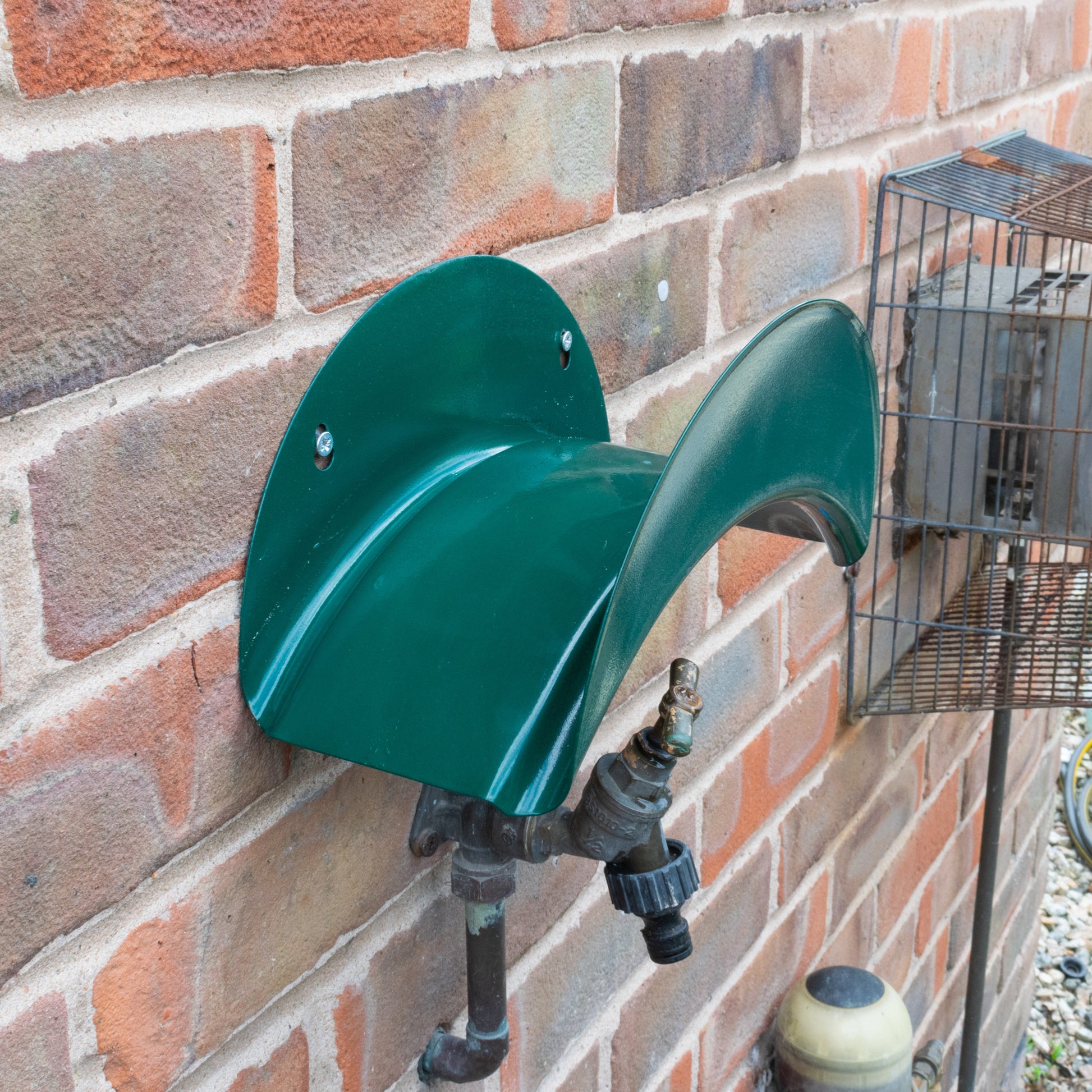 Green double-curved metal hose hanger cradle with wall-mount fittings