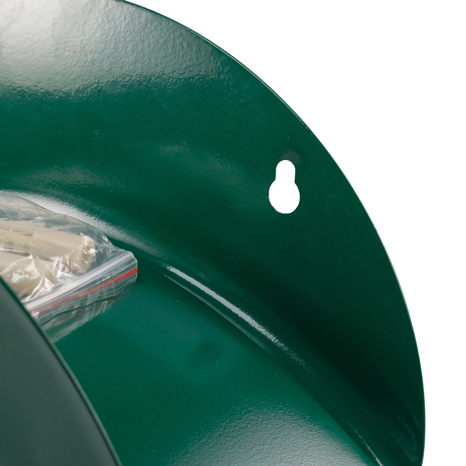 Green metal hose hanger close-up of curved cradle and white mounting-hole marker