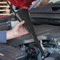 Long black funnel spout held beside car engine bay