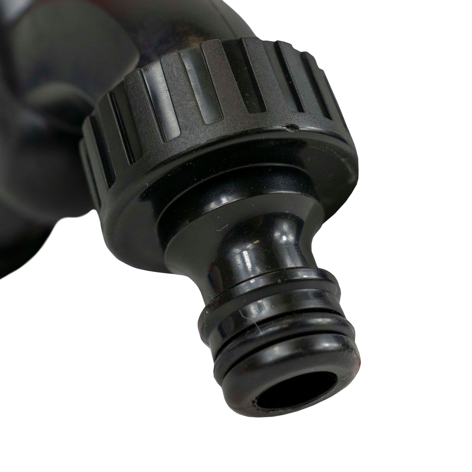 Close-up of black water butt tap hose outlet with ribbed grip