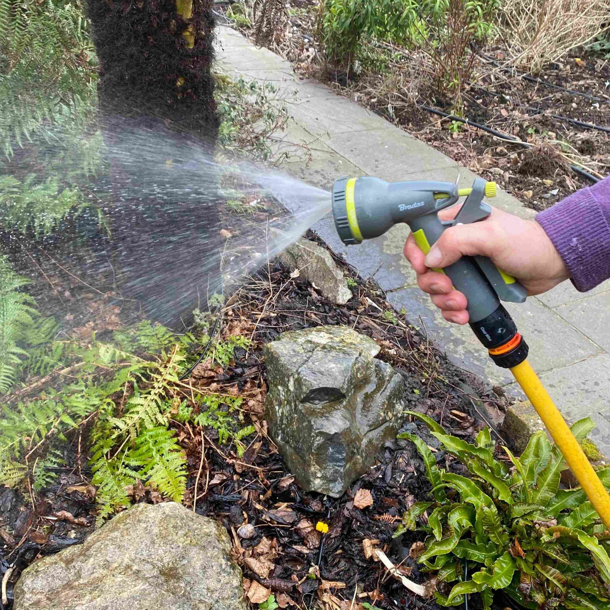 Lime garden hose water sprayer with adjustable spray, water jet from nozzle