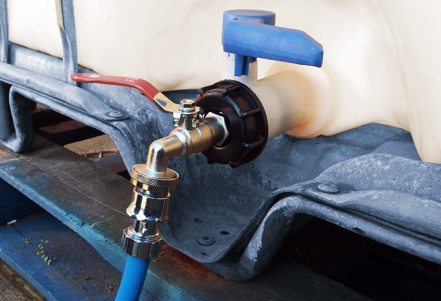 IBC Tank Connection Kit chrome outlet with blue hose connected to a valve on IBC