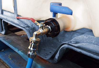 IBC Tank Connection Kit chrome outlet with blue hose connected to a valve on IBC