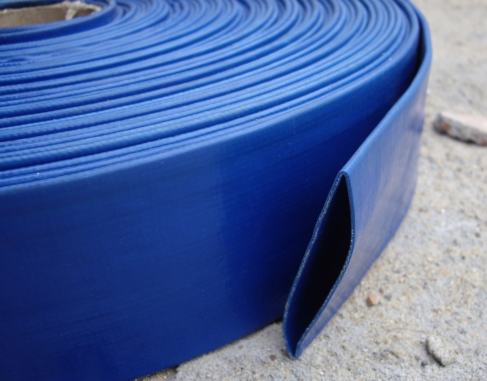 Blue lay flat 2" PVC hose roll with side edge and U-shaped channel