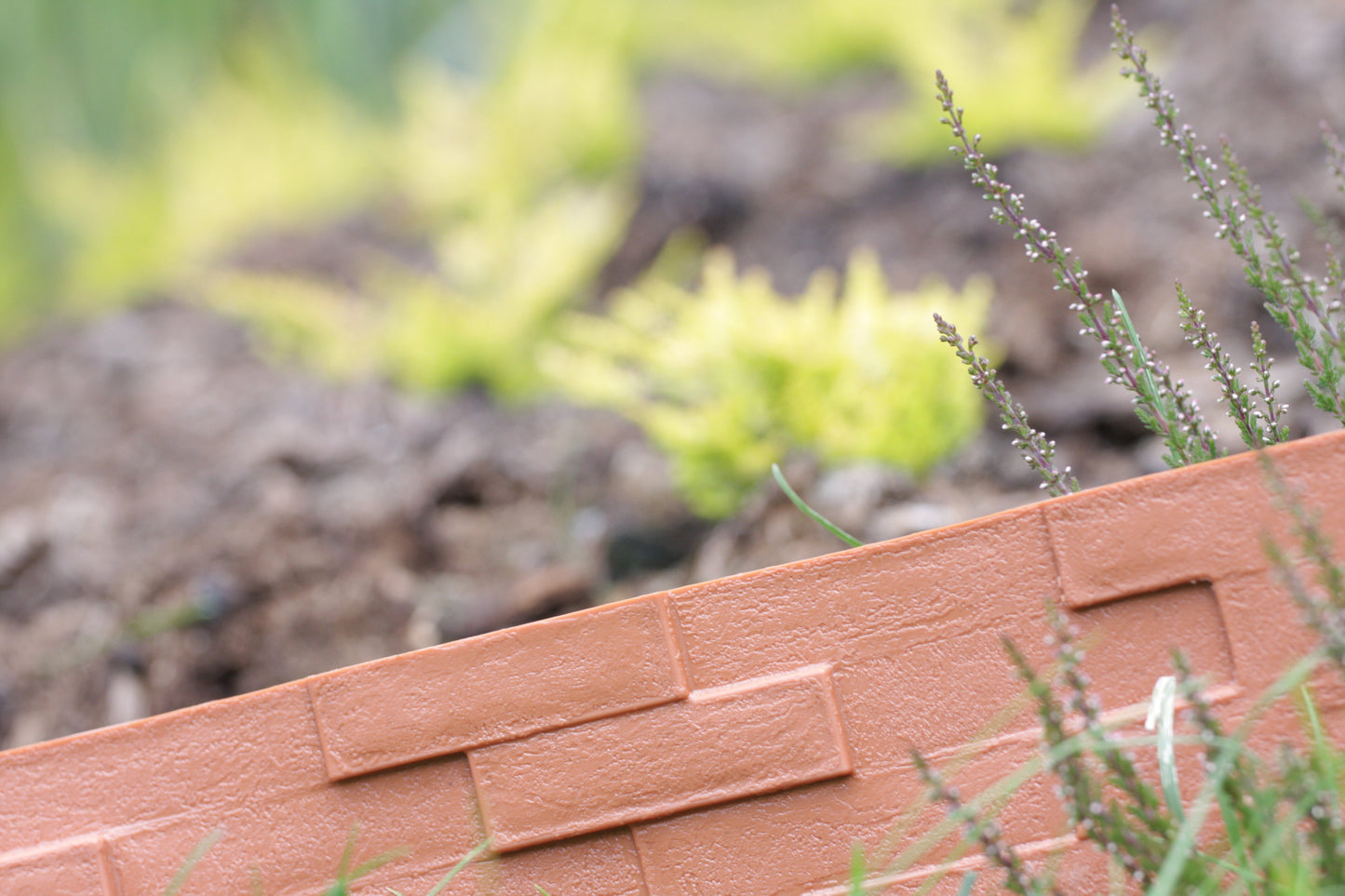 Slate-effect gray plastic edging close-up, showing textured top edge