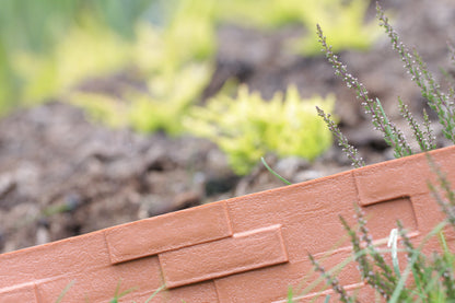 Slate-effect gray plastic edging close-up, showing textured top edge