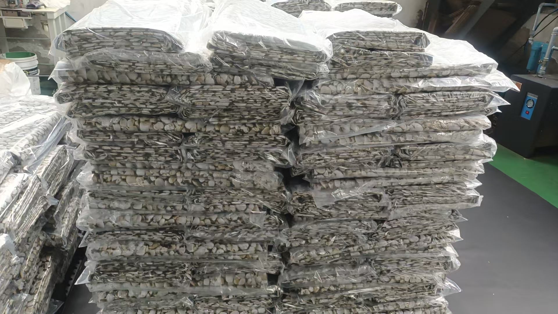 Stacked pebble-pattern PVC pond liner sheets, bundled for 5m x 5m