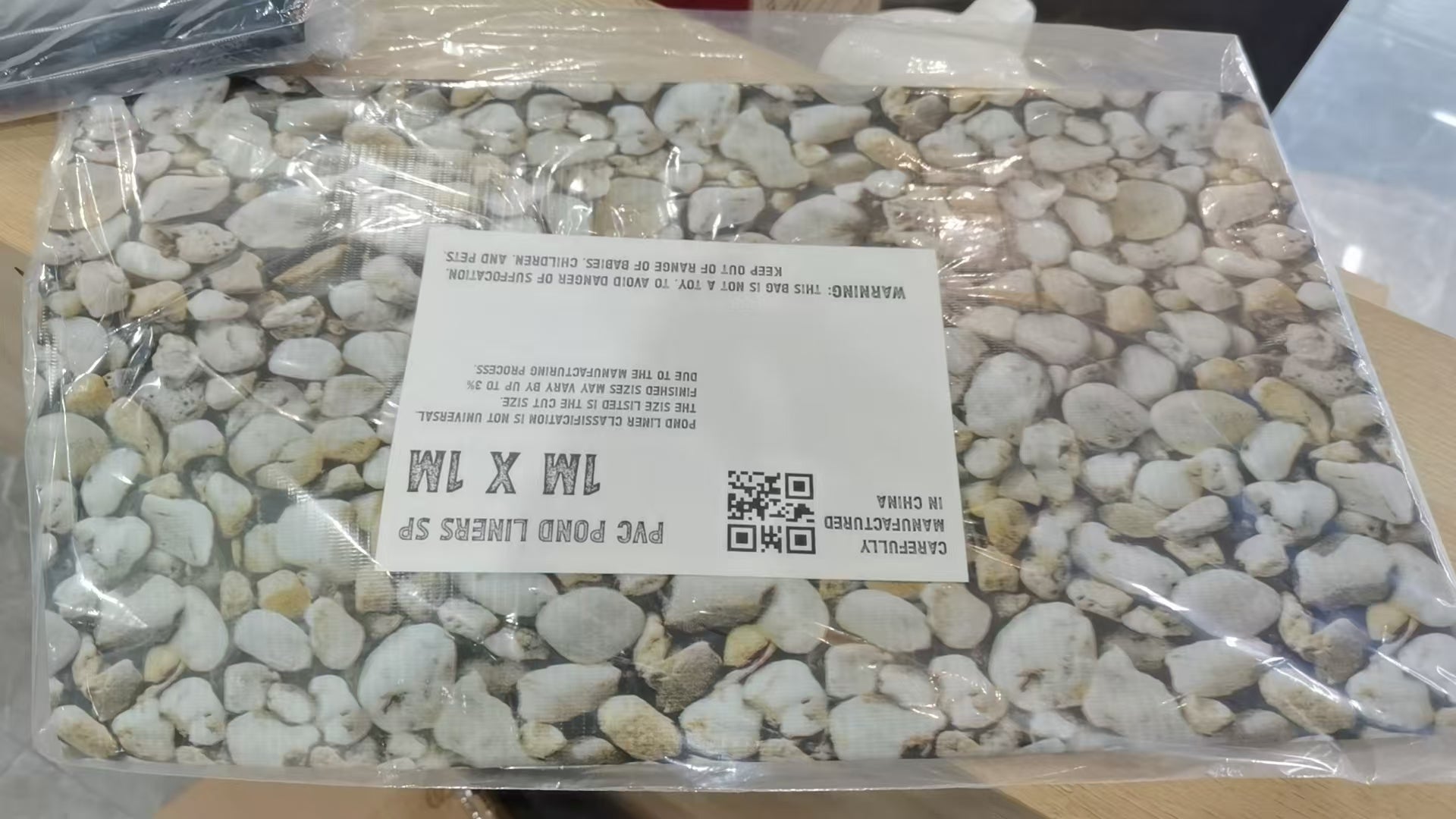 Pebble print PVC pond liner in plastic bag with product label and QR code