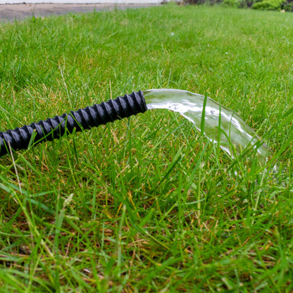 Black corrugated pipe with end releasing a water stream (1 inch/25mm)
