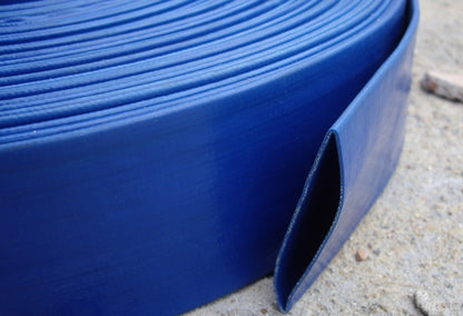 Blue lay flat 2" PVC hose section showing side edge and channel opening