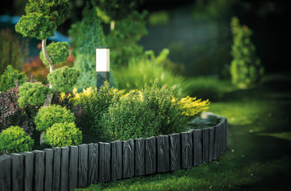 Gray plastic lawn edging curve with wood-effect panels and evenly spaced stakes