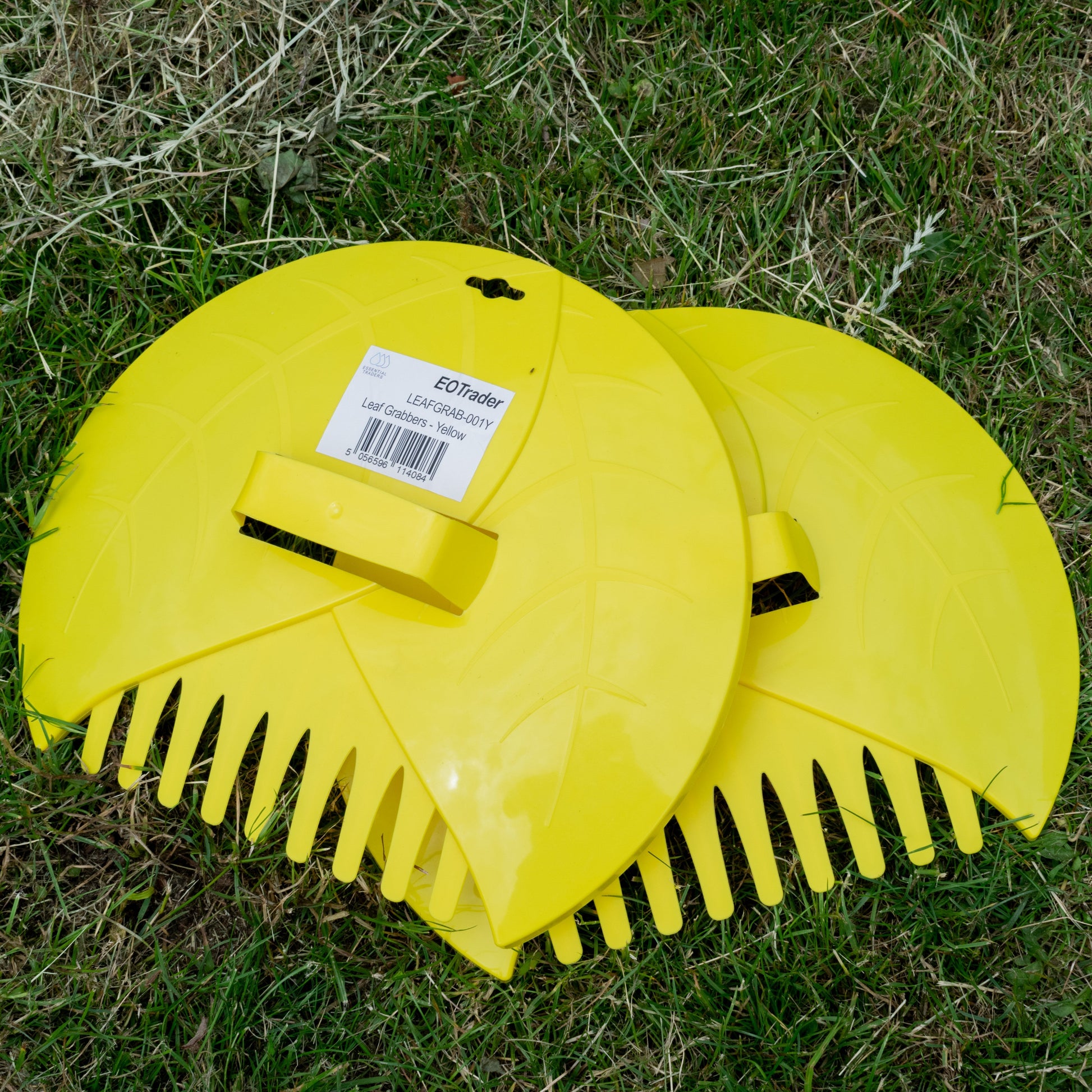 Yellow leaf grabber garden scoop with comb-like rake teeth and central handle