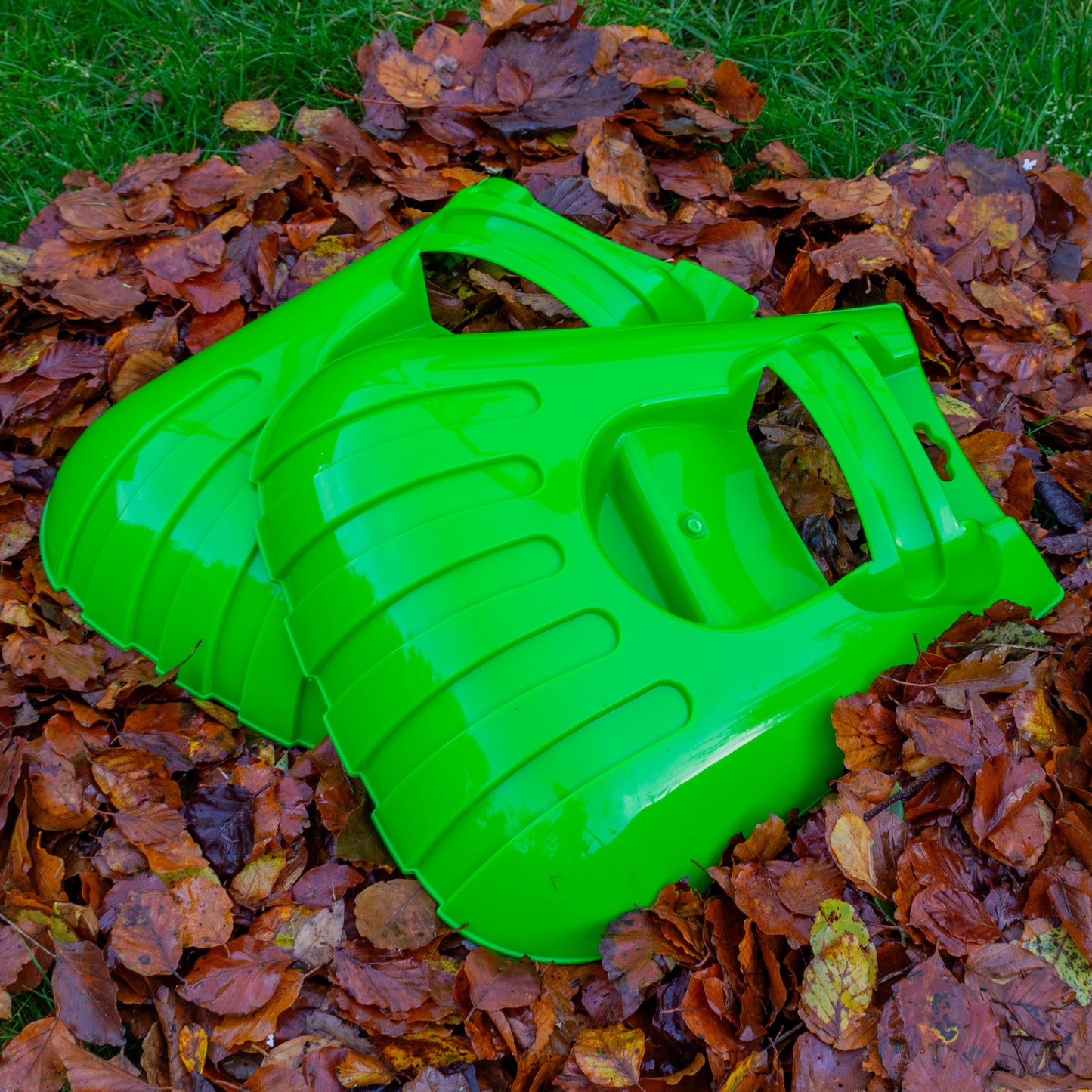 Large green leaf grab garden scoop with curved rake-like teeth for collecting leaves