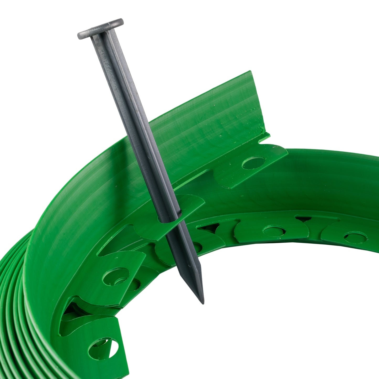 Green lawn edging border with a metal peg stake inserted through the plastic slots